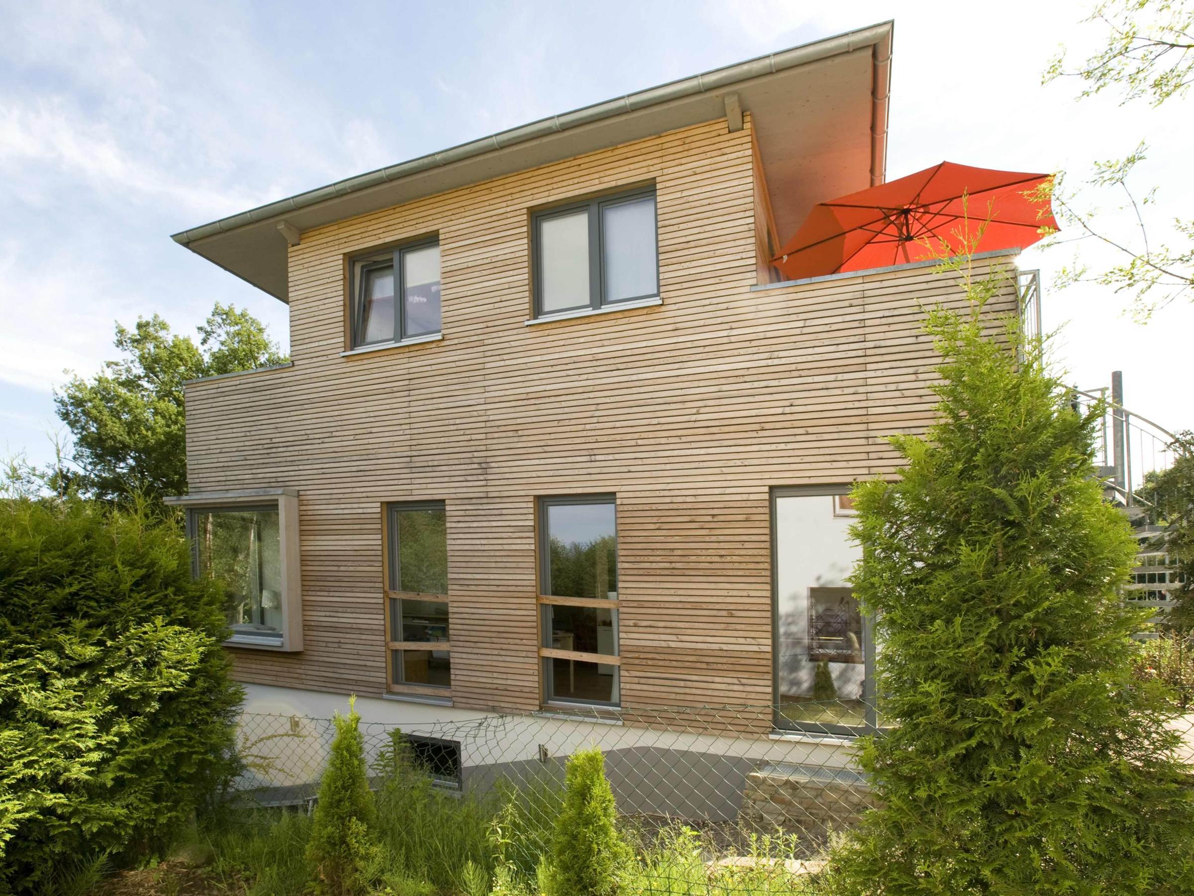 Seitenansicht des Anbaus mit waagerechter Holzfassade aus Lärche